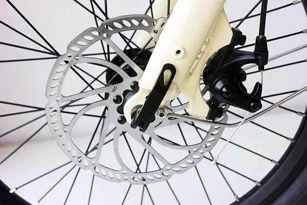 A close-up of a cargo e-bike's robust front tire and brake system.