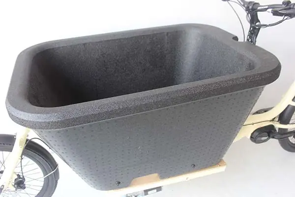 A large cargo e-bike with a one-piece molded plastic basket.