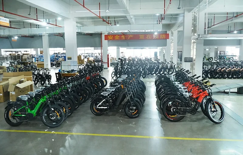 A business owner reviewing paperwork with a calculator, showing savings from e-bike subsidies.