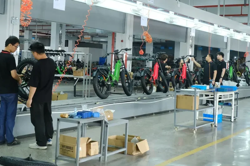 Workers assembling e-bikes in a modern factory