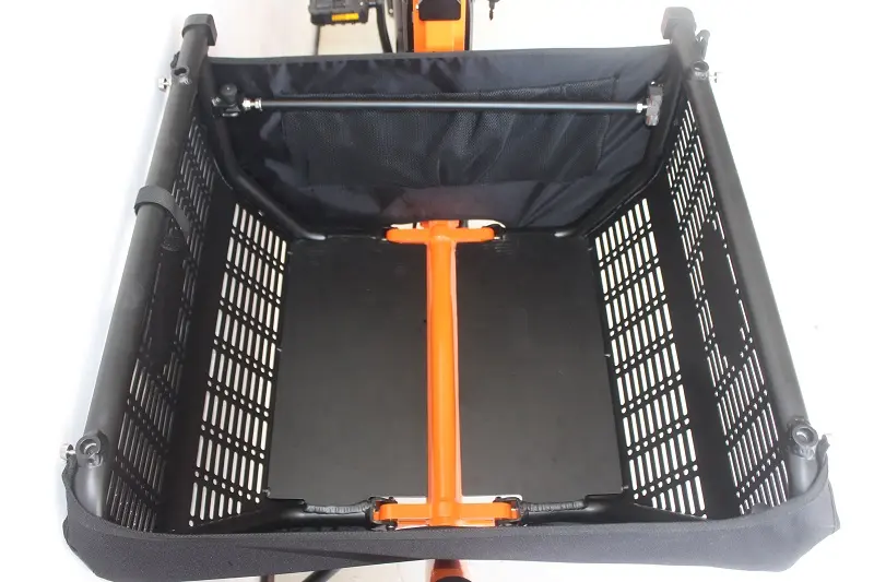 An empty, reinforced aluminum cargo box on an e-bike, showing its sturdy construction.