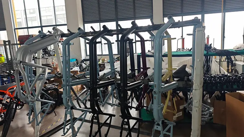 A fleet of cargo electric bikes lined up in a European city street