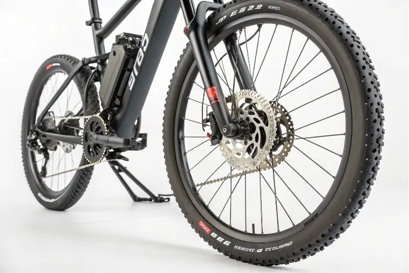 An electric bike with hydraulic disc brakes in a workshop