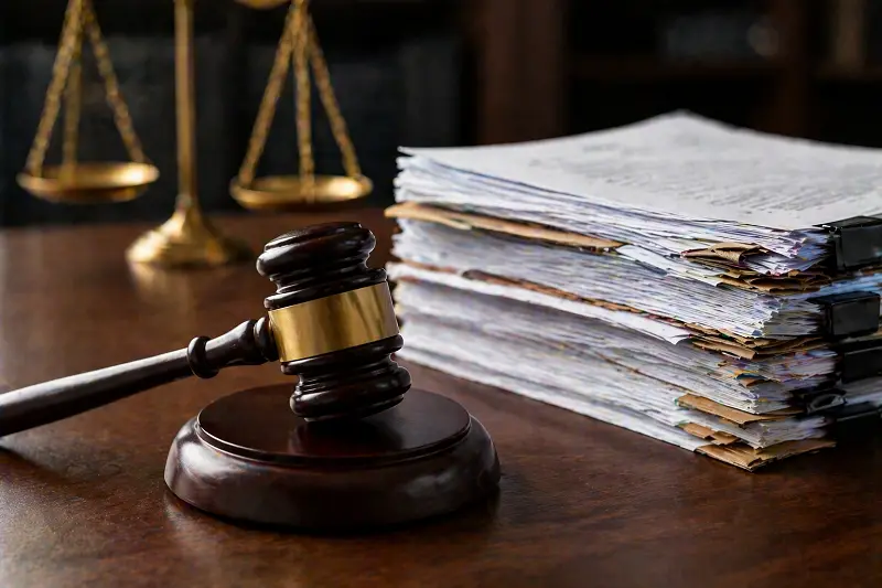 A gavel and a stack of legal documents.