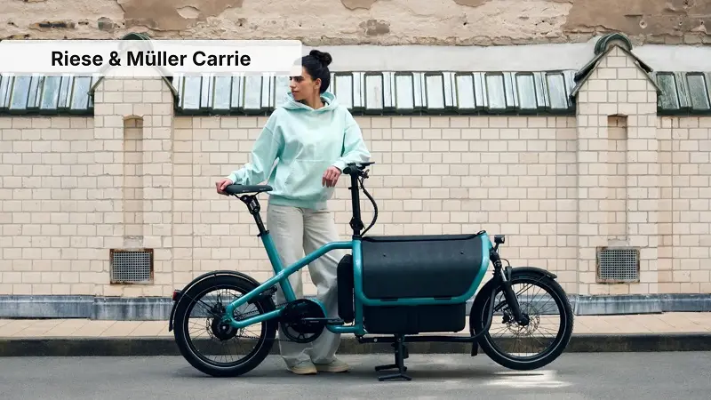 A front-loading cargo electric bike in a city setting.