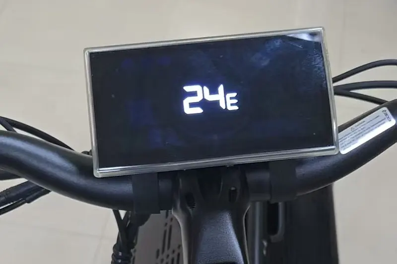 A frustrated customer looking at an e-bike with an error code on the display