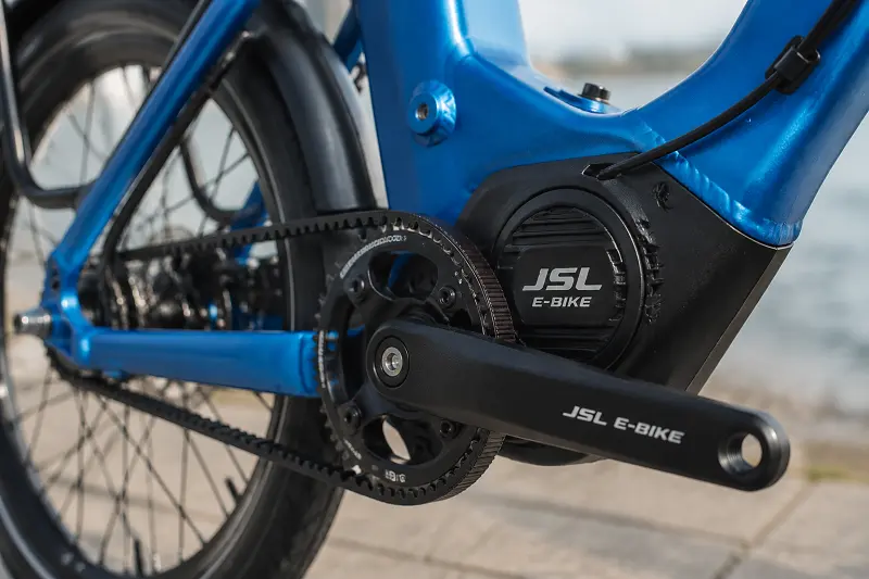 E-Bike Technology for Winter A close-up of a mid-drive motor and belt drive on an e-bike